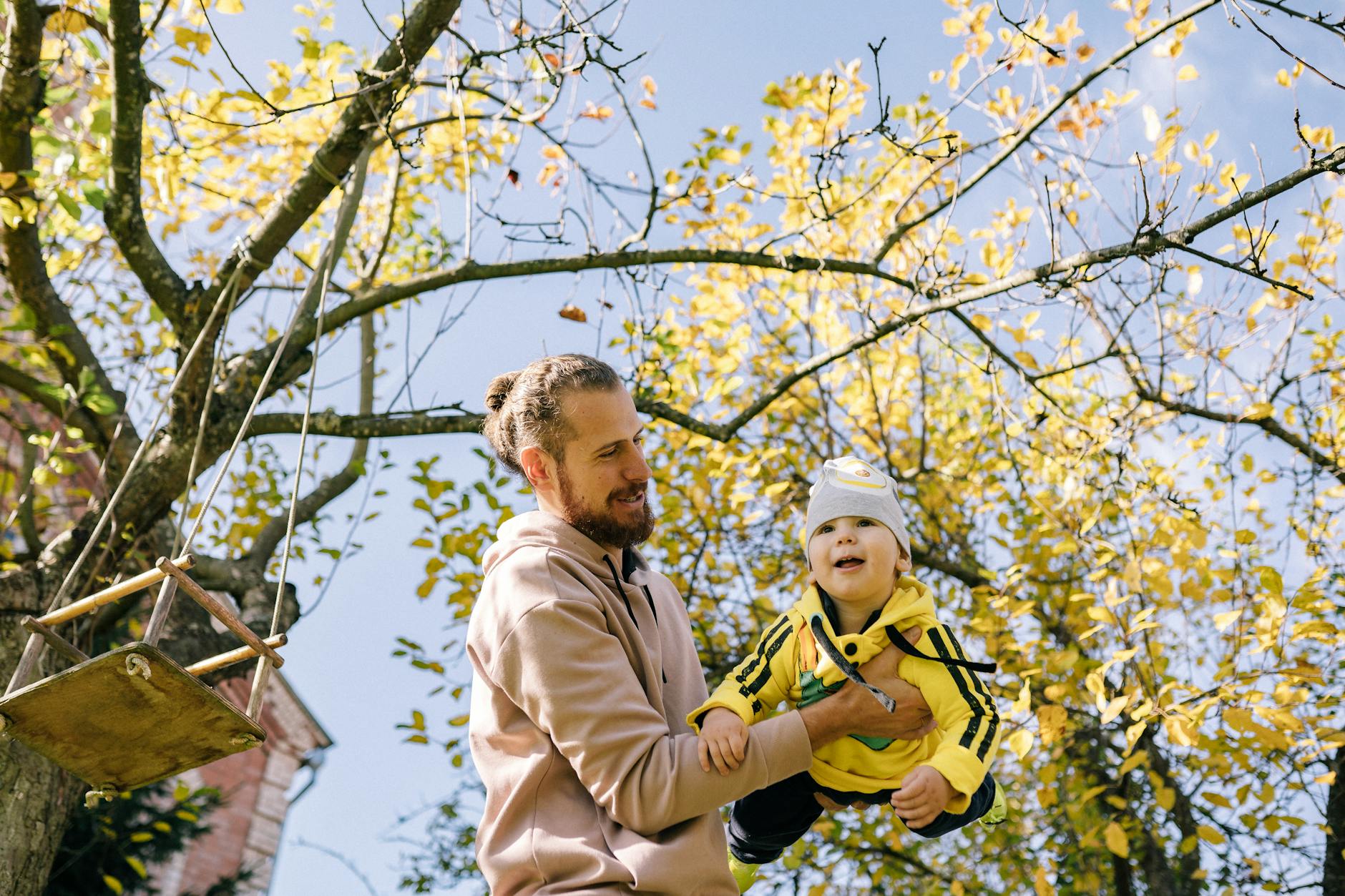 man carrying baby outside